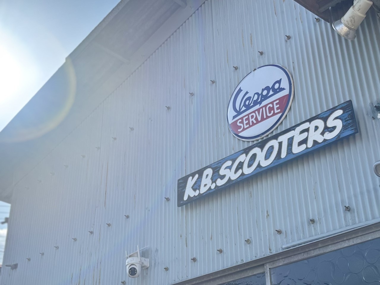K.B.SCOOTERSの外壁に掲げられたVespa Serviceの看板